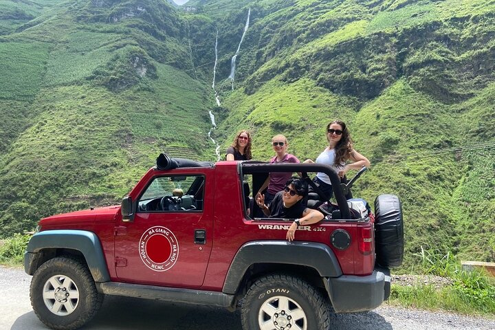 Local driver guides a jeep through the winding mountain road of the Ha Giang Loop