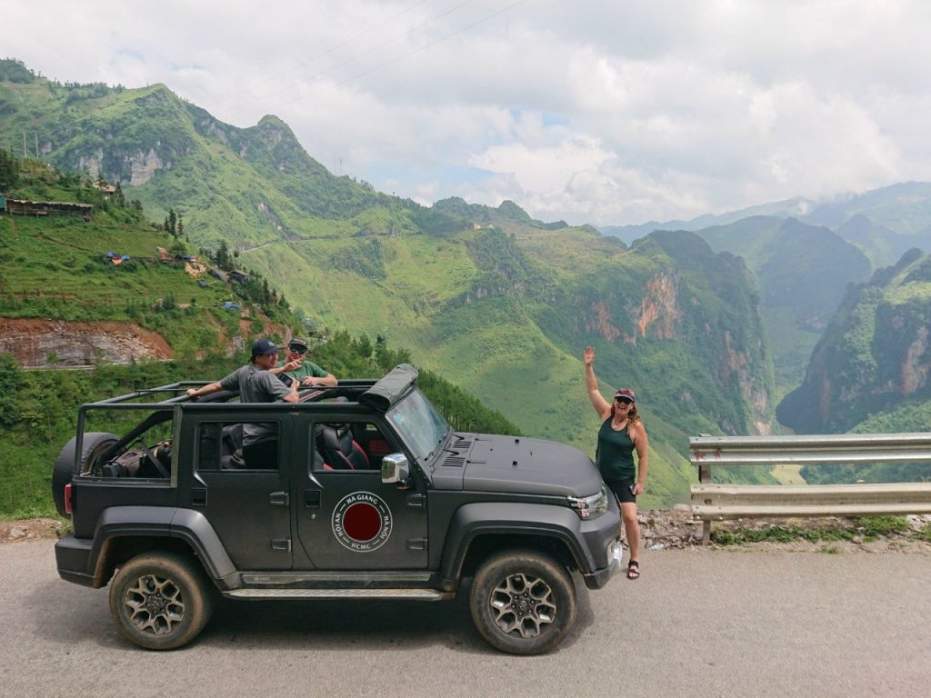 A Ha Giang Jeep Tour family crossing rural roads near Du Gia with a local guide — a journey of comfort and care. 