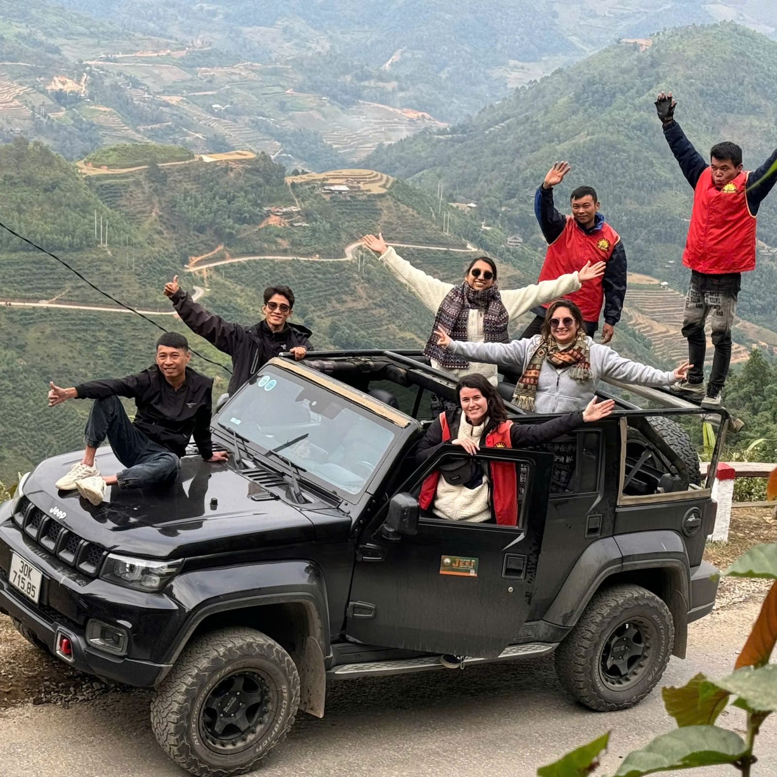 A couple and family jeep ride through the Ha Giang Loop mountains with QT Motorbikes & Tours — quiet, safe, and real.