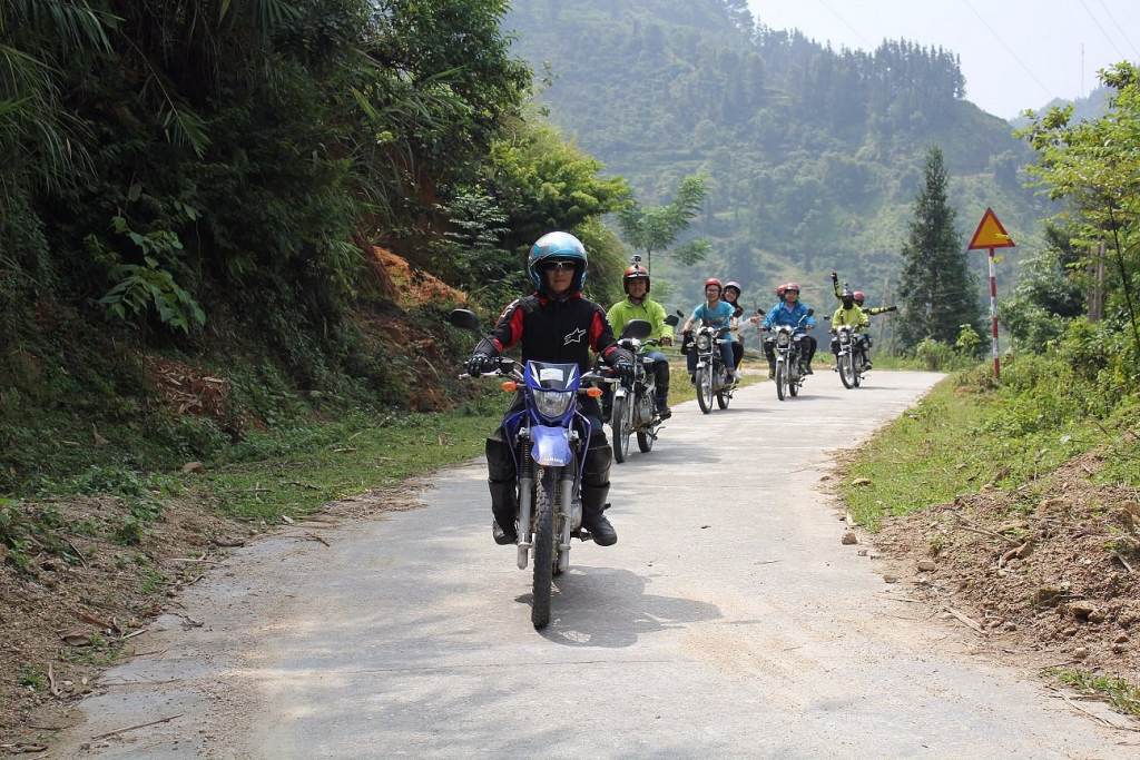 Winding Scenic Ha Giang Motorbike Routes through Dong Van Karst Plateau and Ma Pi Leng Pass, overlooking Tu San Canyon and Meo Vac valley.