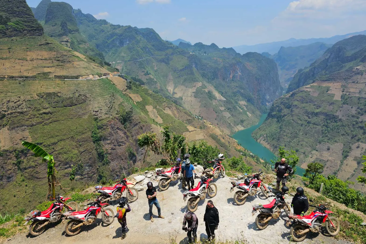 Ha Giang Loop Motorbike Tour – motorbikes riding through Ma Pi Leng Pass in northern Vietnam.