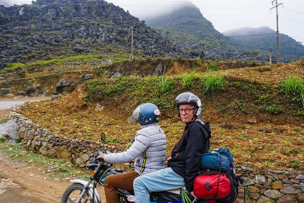Local guide leads travelers on the Ha Giang Easy Rider Motorbike Tour through misty mountain roads near Quan Ba Heaven’s Gate.